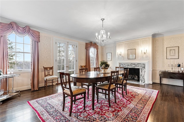 265 Scaife Rd, Sewickley Heights, PA 15143 - dining space with healthy amount of natural light, a chandelier, dark wood finished floors, wallpapered walls, and ornamental molding