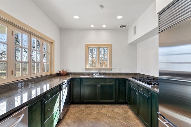 265 Scaife Rd, Sewickley Heights, PA 15143 - kitchen featuring appliances with stainless steel finishes, green cabinetry, dark stone counters, recessed lighting, and a sink