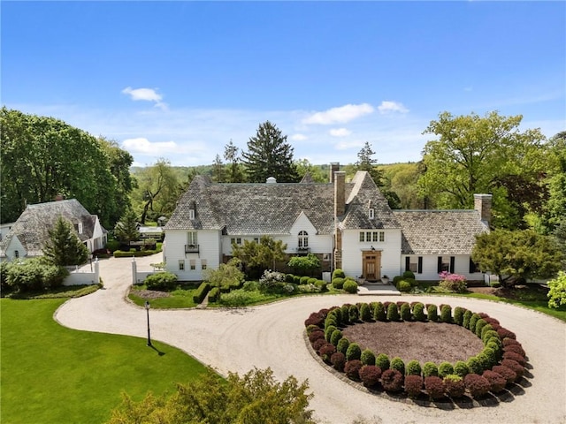 265 Scaife Rd, Sewickley Heights, PA 15143 - view of front facade with curved driveway, a chimney, and a front lawn