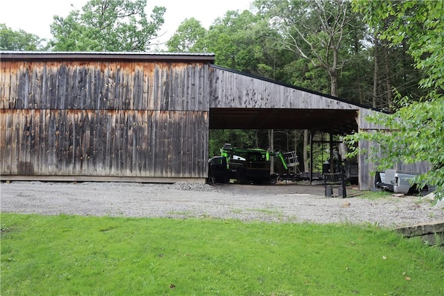 view of community with a yard, an outdoor structure, and a pole building