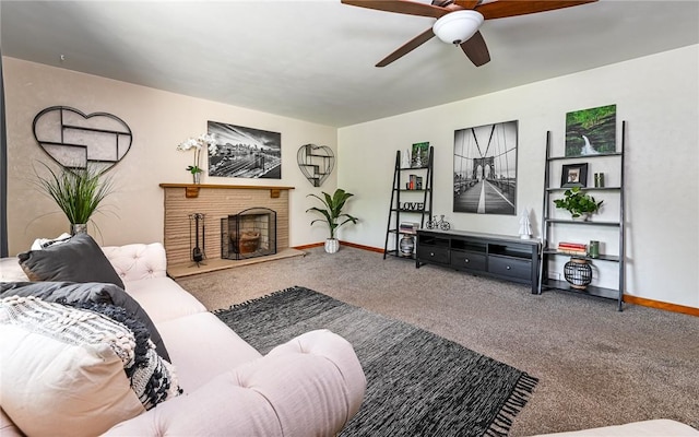 carpeted living area featuring a ceiling fan, baseboards, and a fireplace with raised hearth