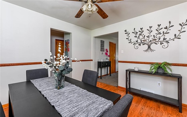 dining area featuring a ceiling fan and wood finished floors