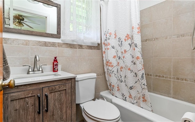 bathroom with shower / bathtub combination with curtain, toilet, tile walls, vanity, and tasteful backsplash