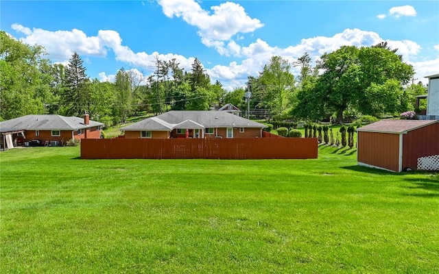 view of yard featuring a storage shed and an outdoor structure