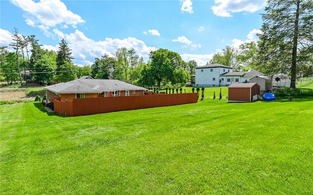 view of yard featuring a storage unit and an outbuilding
