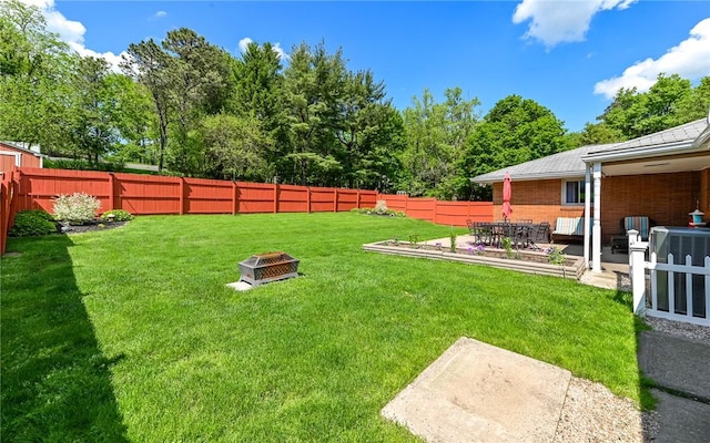 view of yard with an outdoor fire pit and a patio