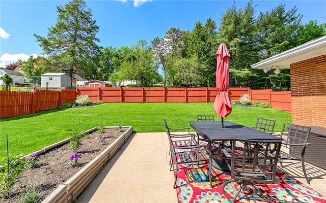 view of patio / terrace with a vegetable garden and outdoor dining area