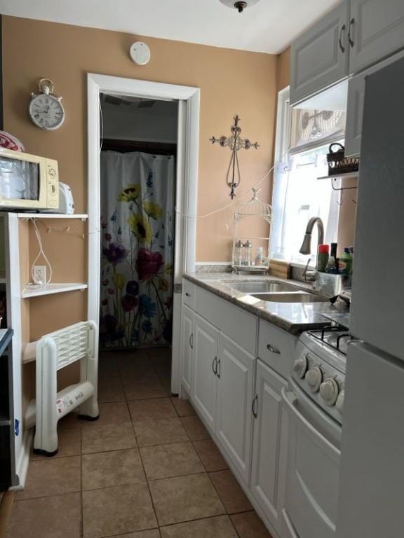 41 Sylvia Ave, Ross Twp, PA 15214 - kitchen featuring white appliances, a sink, white cabinetry, light tile patterned flooring, and light countertops