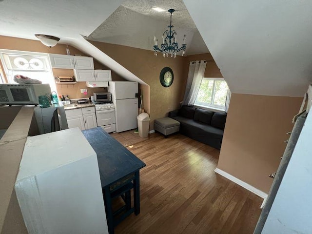 41 Sylvia Ave, Ross Twp, PA 15214 - living area with vaulted ceiling, light wood-style flooring, and a chandelier
