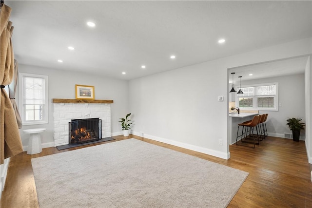 3334 Comanche Rd, Upper St Clair, PA 15241 - living area with recessed lighting, wood finished floors, a stone fireplace, and baseboards