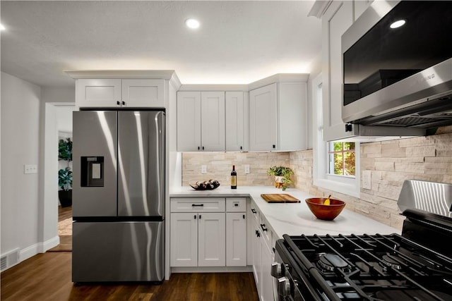 3334 Comanche Rd, Upper St Clair, PA 15241 - kitchen featuring stainless steel appliances, backsplash, light countertops, dark wood-style floors, and white cabinetry