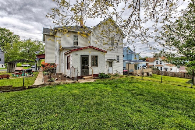 rear view of house featuring a chimney