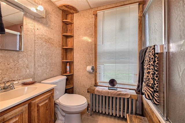 full bathroom with radiator, a shower with shower door, toilet, tile patterned flooring, and vanity