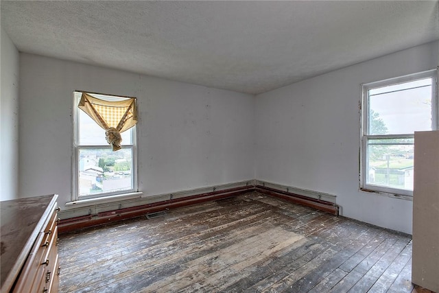 unfurnished room featuring hardwood / wood-style flooring and plenty of natural light