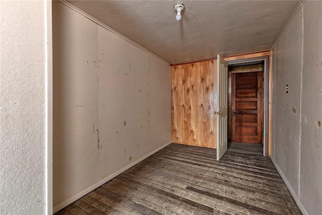 spare room with dark wood-type flooring and a textured ceiling