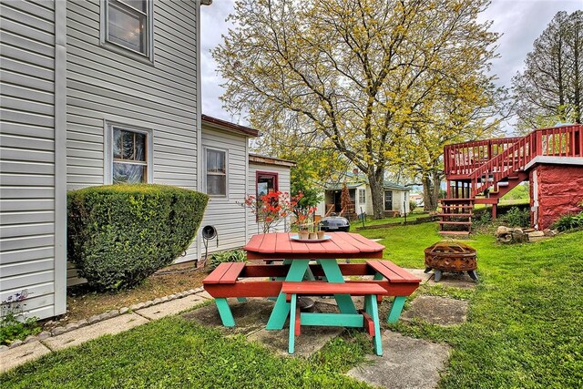 257 Lavansville Rd, Somerset Twp, PA 15501 - view of grassy yard featuring an outdoor fire pit, stairs, and outdoor dining area