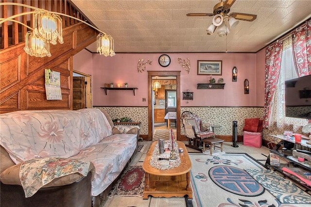 257 Lavansville Rd, Somerset Twp, PA 15501 - living room with ceiling fan, a wainscoted wall, and a chandelier