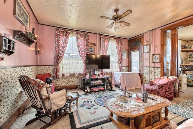 257 Lavansville Rd, Somerset Twp, PA 15501 - living area with a ceiling fan, wallpapered walls, carpet floors, and ornate columns