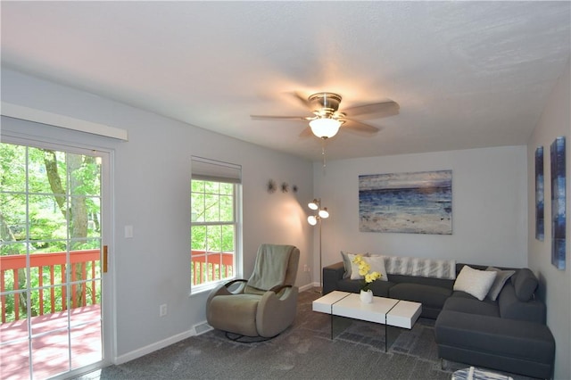 living area with carpet floors, a ceiling fan, and baseboards