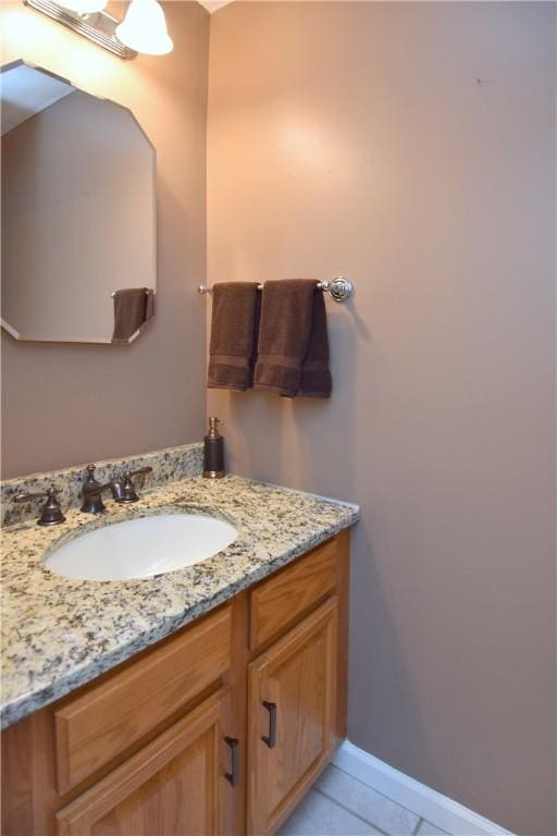 bathroom with vanity, tile patterned floors, and baseboards