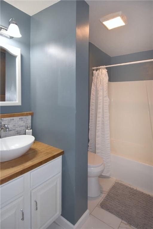 full bathroom with decorative backsplash, toilet, vanity, shower / tub combo with curtain, and tile patterned floors