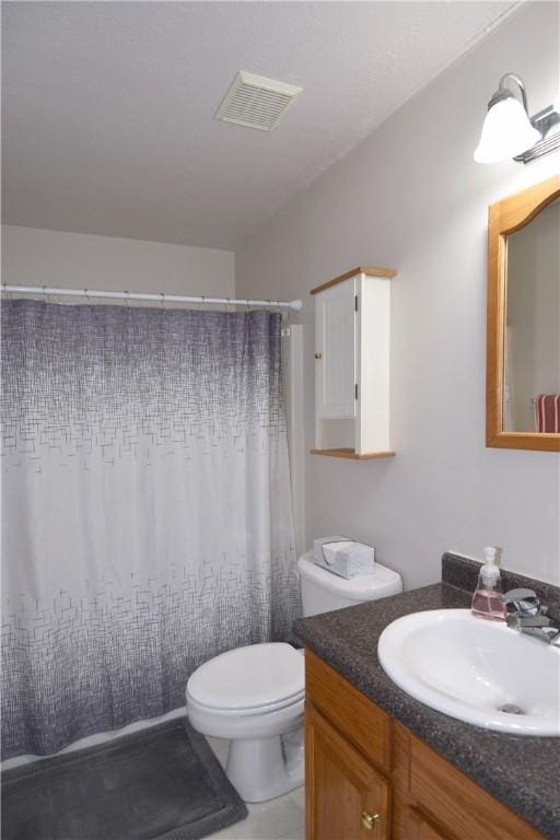 bathroom featuring toilet, vanity, and a shower with shower curtain