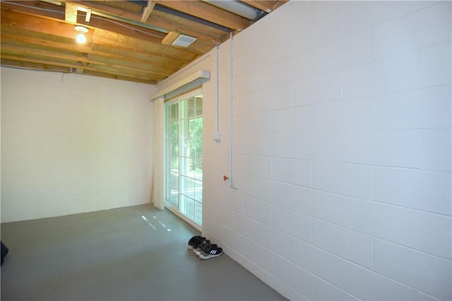 below grade area featuring concrete block wall