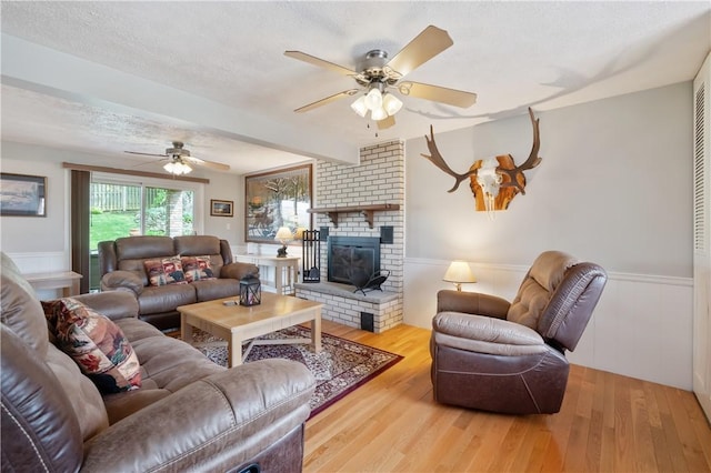 3 Patricia St, Fallowfield, PA 15022 - living area with a ceiling fan, wood finished floors, wainscoting, and a fireplace