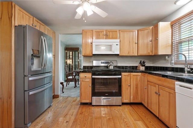 3 Patricia St, Fallowfield, PA 15022 - kitchen with appliances with stainless steel finishes, a sink, light wood-style flooring, a ceiling fan, and tile counters