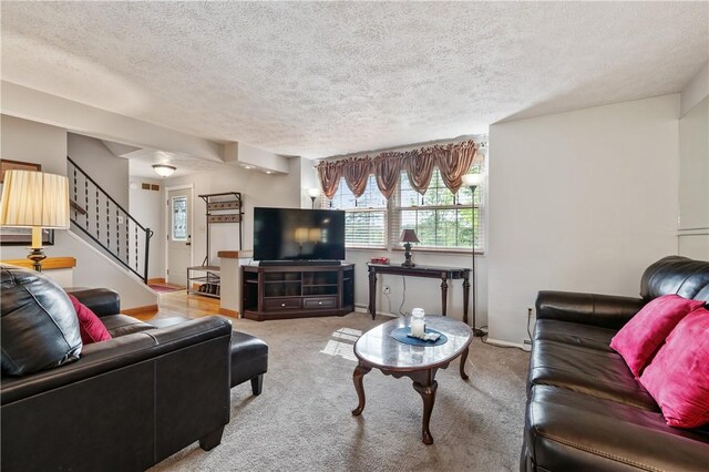 3 Patricia St, Fallowfield, PA 15022 - carpeted living room featuring a textured ceiling, stairs, and baseboards
