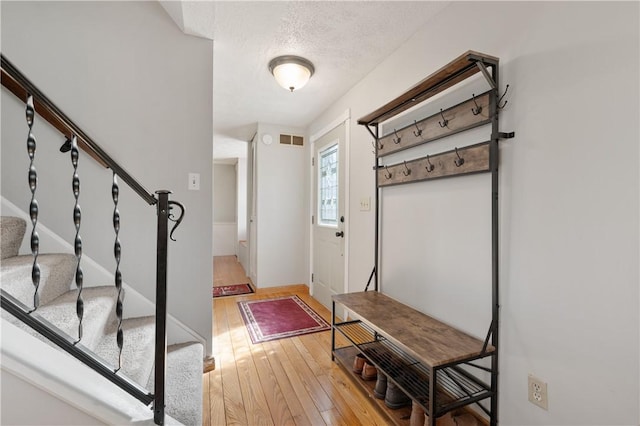 3 Patricia St, Fallowfield, PA 15022 - entryway featuring light wood-style floors, stairway, a textured ceiling, and baseboards