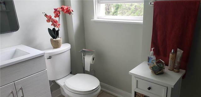 half bathroom featuring vanity and toilet
