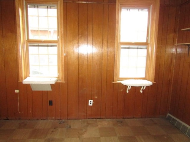 2101 Wharton St, South Side, PA 15203 - empty room featuring tile patterned floors, plenty of natural light, and wood walls