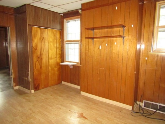 2101 Wharton St, South Side, PA 15203 - unfurnished bedroom featuring wood finished floors, wooden walls, and baseboards
