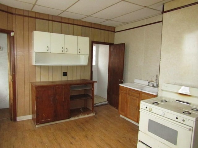 2101 Wharton St, South Side, PA 15203 - kitchen with white range with gas cooktop, light wood-style flooring, wood walls, a drop ceiling, and light countertops