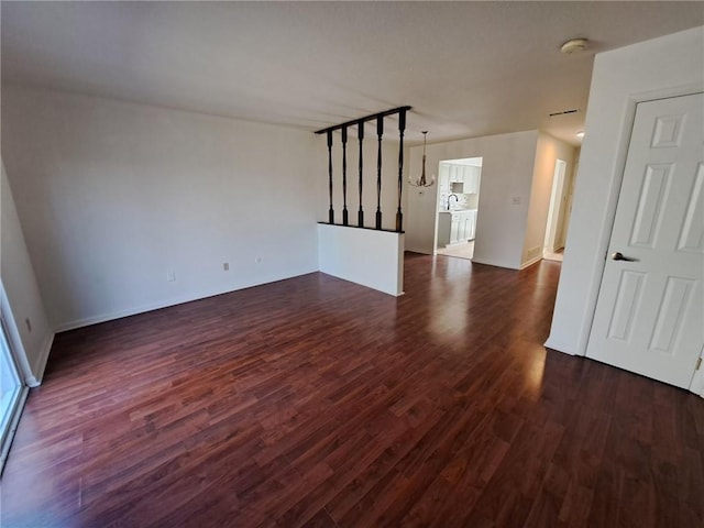 115 College Park Dr, Moon/Crescent Twp, PA 15108 - unfurnished living room with dark wood-style floors, a chandelier, a sink, and baseboards