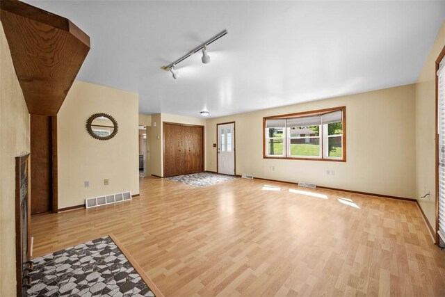 2918 Woodland Cir, Hampton, PA 15101 - unfurnished living room featuring light wood-type flooring, track lighting, and baseboards