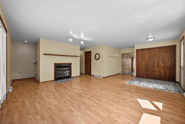 2918 Woodland Cir, Hampton, PA 15101 - unfurnished living room with light wood-style floors, baseboards, a fireplace with flush hearth, and stairway