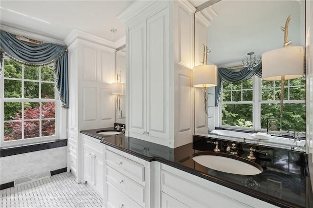 bathroom featuring vanity, tile patterned floors, and a bath