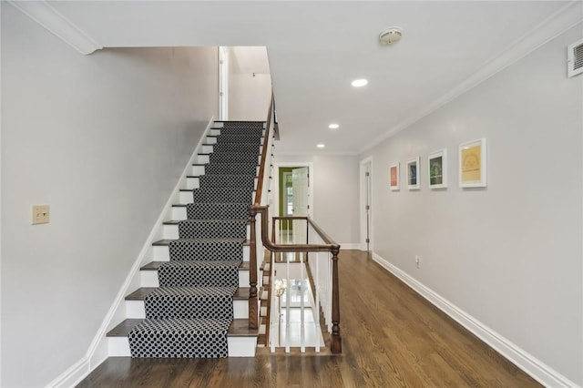 stairs featuring wood finished floors, recessed lighting, baseboards, and ornamental molding