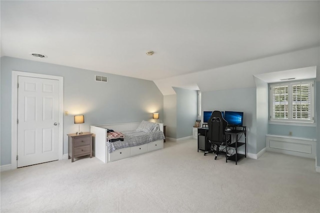carpeted bedroom featuring vaulted ceiling, a desk, and baseboards