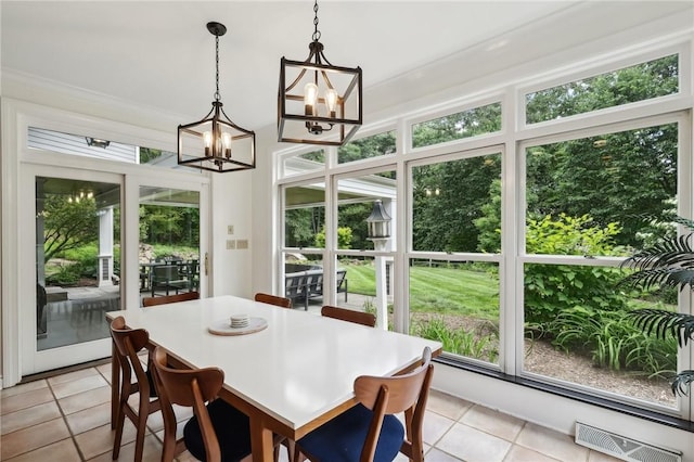 dining area featuring a chandelier and light tile patterned floors