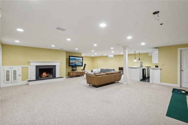 living room with light colored carpet, a warm lit fireplace, and recessed lighting