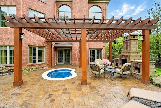 view of patio featuring an outdoor stone fireplace and a pergola
