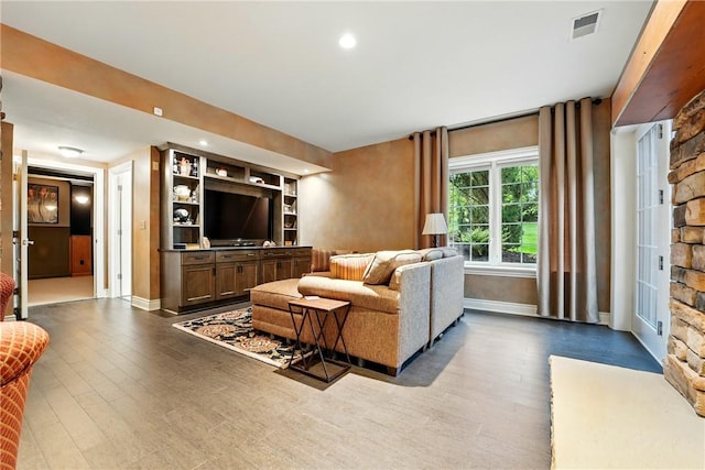 living area with wood finished floors, baseboards, and recessed lighting