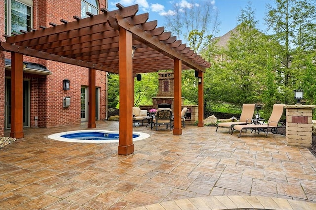 view of patio / terrace with an outdoor fireplace, a pergola, and an in-ground hot tub