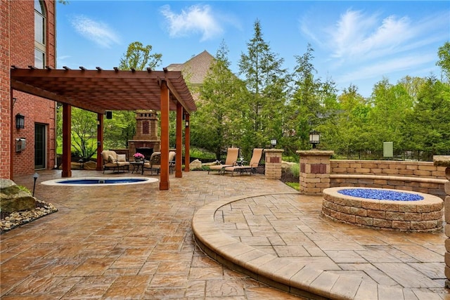 view of patio / terrace featuring an outdoor stone fireplace, a fire pit, and a pergola