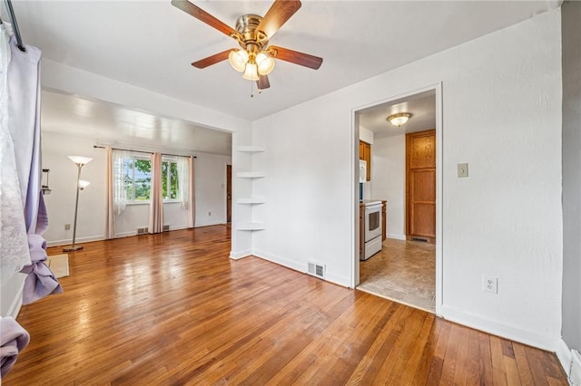 339 Hamil Rd, Penn Hills, PA 15147 - spare room with light wood-type flooring, ceiling fan, baseboards, and built in shelves