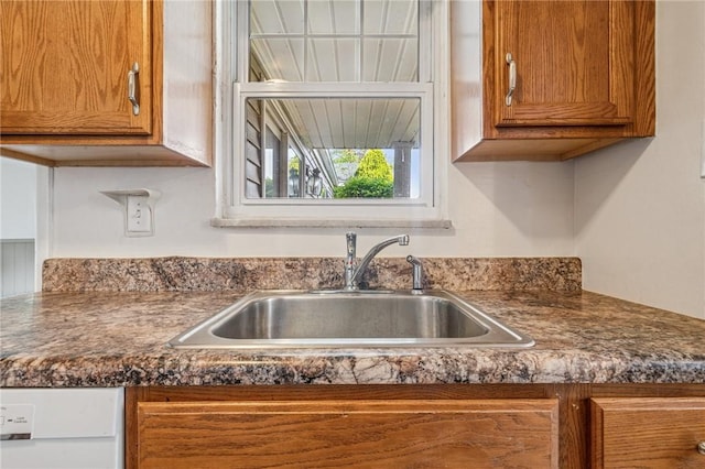 339 Hamil Rd, Penn Hills, PA 15147 - kitchen with a sink, dark countertops, and brown cabinetry