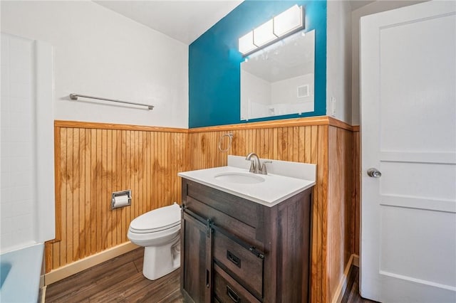 339 Hamil Rd, Penn Hills, PA 15147 - bathroom featuring wainscoting, wood finished floors, toilet, wood walls, and vanity